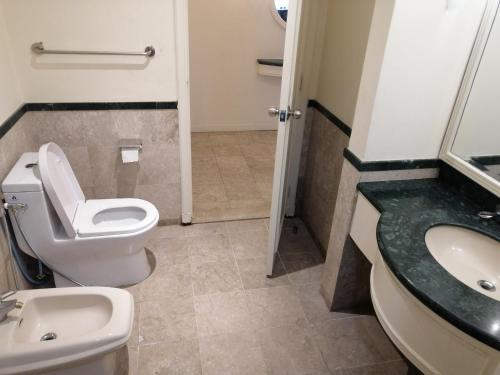 a bathroom with a toilet and a sink at Kl Continew Suite At Times Square in Kuala Lumpur