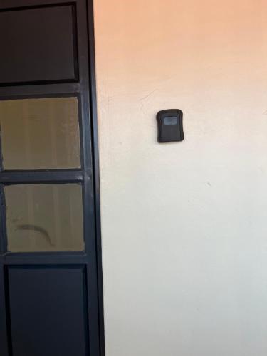 a door with a black handle next to a window at Exquisite Modern suite 1bedroom in Busia