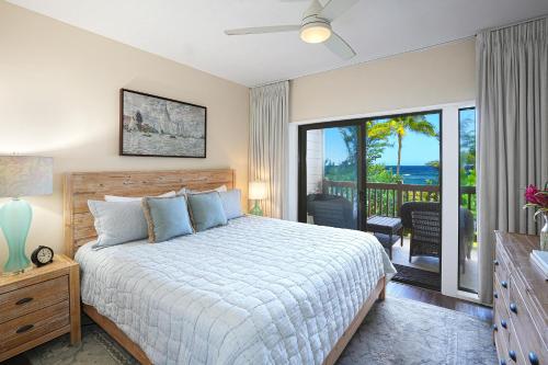 a bedroom with a bed and a balcony at Kaha Lani #222 in Lihue