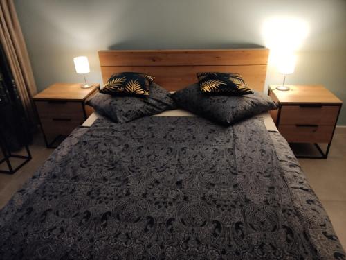 a bedroom with a bed with pillows and two lamps at Wolke 12 in Gorzów Wielkopolski