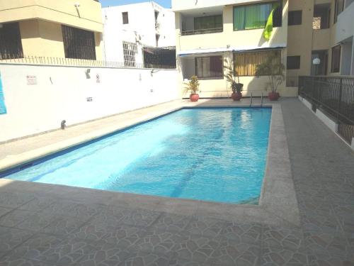 a swimming pool in front of a building at Tucurinca in Santa Marta
