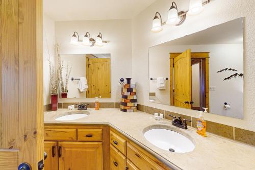 a bathroom with two sinks and a large mirror at Running Bear in the Rockies #6145 in Estes Park