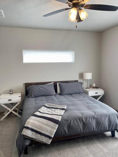 a bedroom with a bed and a ceiling fan at Post Falls Hideaway New 4 Bedroom Home Short Term in Post Falls