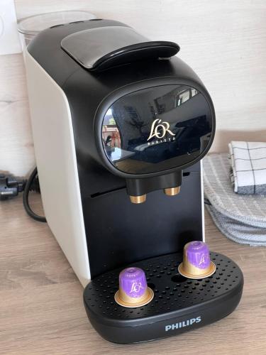 a sewing machine with purple caps on top of it at Plage Cabourg 7 Vue Mer in Cabourg