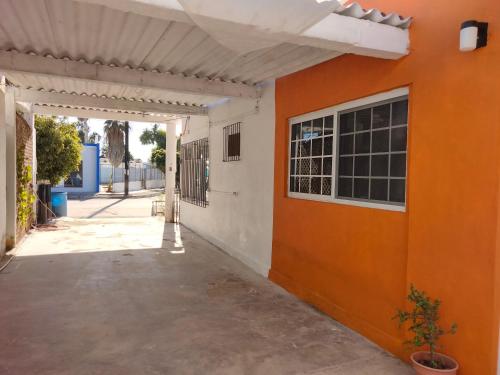 an orange and white wall with a window at Casa Kayack in San Carlos