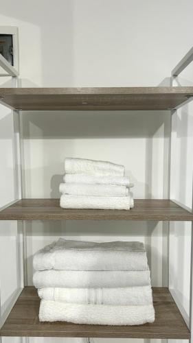 a stack of towels on a shelf in a bathroom at Anna B&B in Ungheni