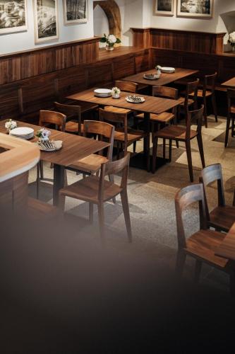 a dining room with wooden tables and chairs at Bootshaus Amberg in Amberg