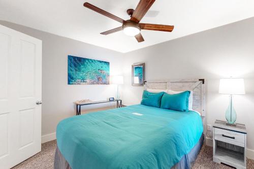a bedroom with a bed and a ceiling fan at Berni's Ocean View Castle - Home Sweet Homestead in Oceanside