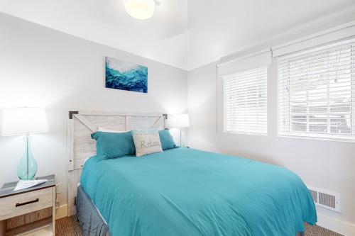 a bedroom with a blue bed and a window at Berni's Ocean View Castle - an Oceanside Legend in Oceanside