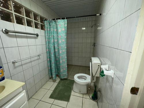 a bathroom with a toilet and a shower at Southside Apartments in Paramaribo