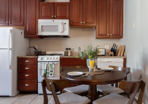 a kitchen with a table and a white refrigerator at Spacious Stay near Yale in Downtown New Haven in New Haven