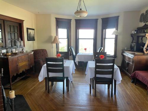 a dining room with a table and chairs and a room with a table at Awakenings Inn in Montague