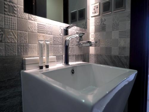 a sink with a faucet in a bathroom at Violet Rose ApartHotel in Jeddah