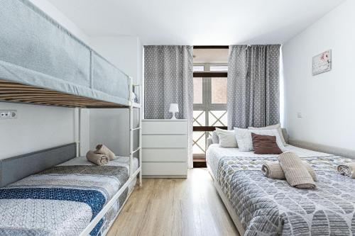 a bedroom with two bunk beds and a window at Open Space in Armação de Pêra