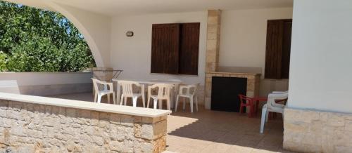 a patio with a table and chairs in a building at Villa Bellino in Castellana Grotte