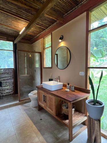 a bathroom with a sink and a toilet and a mirror at Tierra Alta, Refugio de Montaña, Sauce in Sauce