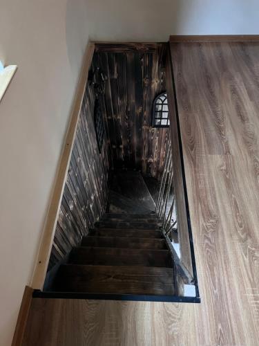 a staircase in a building with a wooden floor at Jeżówka i Sudetka in Jeżów Sudecki
