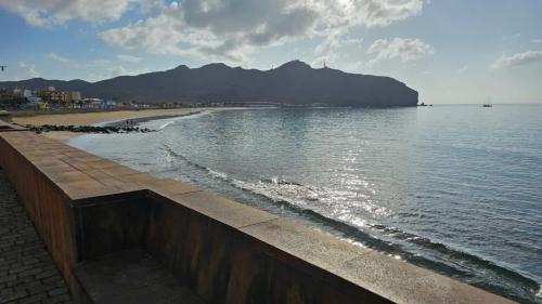 a view of a beach with a mountain in the background at Casa Mararía in Gran Tarajal