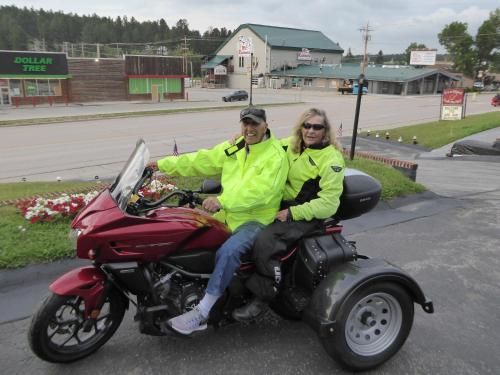 a man and a woman sitting on a motorcycle at Rocket Motel in Custer