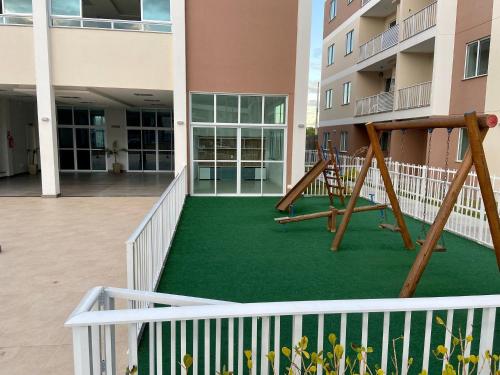 a playground in the courtyard of a building at Lua Nova - Vog Acqua Apt na Praia dos Milionários in Ilhéus