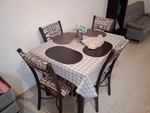 un tavolo con 4 sedie e un tavolo con una tovaglia di Alojamientos holgo a Ciudad Juárez