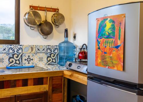 a kitchen with a counter and a refrigerator at The Spot in Esterillos