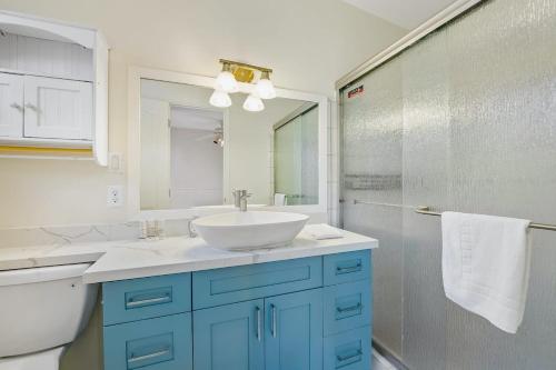 a bathroom with a sink and a toilet and a mirror at @ Marbella Lane - Sunshine Seascape Ocean View in Kaneohe