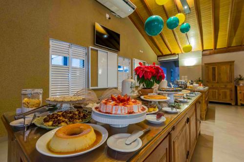 a buffet with many different types of food on a table at Carpe Diem Eco Resort Olímpia in Olímpia