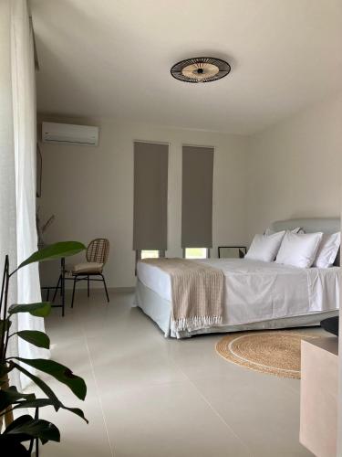 a bedroom with a bed and a table and a chair at Pnoe Eco Residences in Amaliás