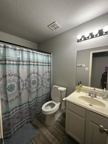 a bathroom with a toilet and a sink at Fresh CrashPads in Houston