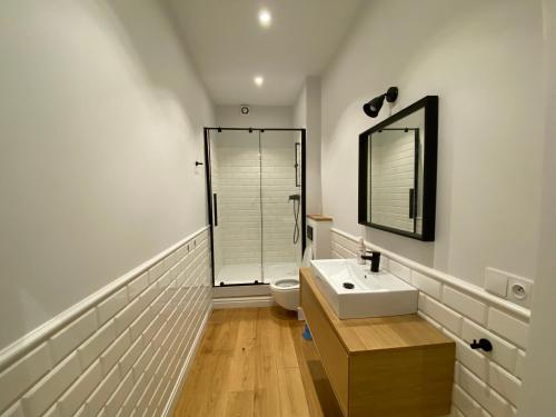 a bathroom with a sink and a toilet and a mirror at Cozy Flat in Rynek in Wrocław