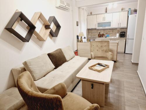 a living room with a couch and chairs and a table at Valentina's Apartment in Olympiada