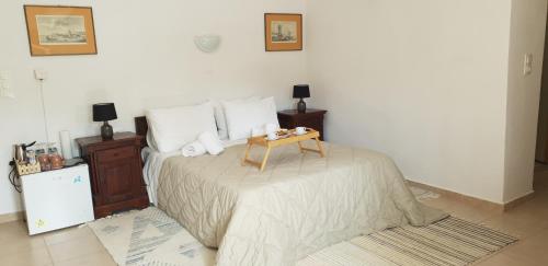 a bedroom with a bed with a table on it at Vilaeti Dimitra in Agios Konstantinos