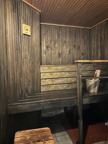 a wooden wall with a bench in a room at Villa Talmo, Kimito island in Kemionsaari