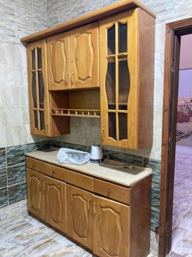 a kitchen with a wooden cabinet in a room at Private roof in Cairo