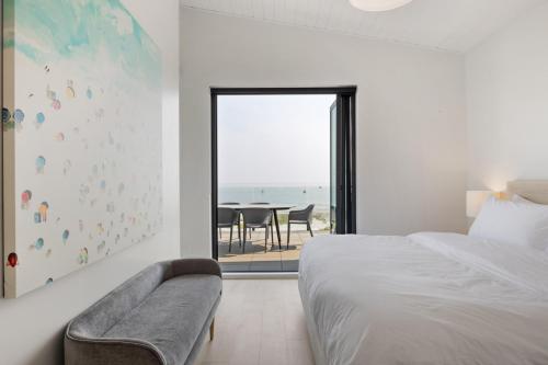 - une chambre avec un lit et une vue sur l'océan dans l'établissement Beachfront Luxury Suite #18 at THE BEACH HOUSE, à Campbell River