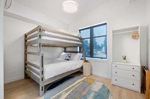 a bedroom with a bunk bed and a window at Beachfront Luxury Suite #18 at THE BEACH HOUSE in Campbell River