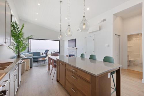 a kitchen and living room with a large island at Beachfront Luxury Suite #18 at THE BEACH HOUSE in Campbell River