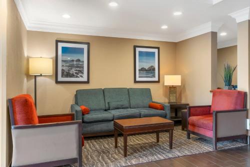 a living room with a couch and two chairs at Comfort Inn Arcata in Arcata