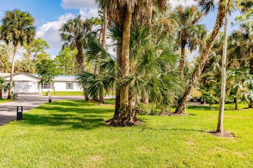 a group of palm trees in a yard at Beautiful Home in Naples with Huge Private Pool in Naples