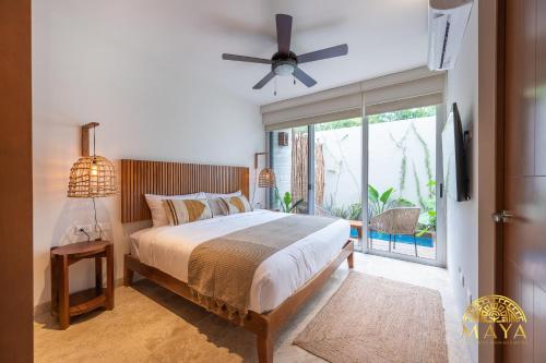 a bedroom with a bed and a ceiling fan at NHOA 108A Lux 2BR Condo Plunge Pool in Aldea Zama in Tulum