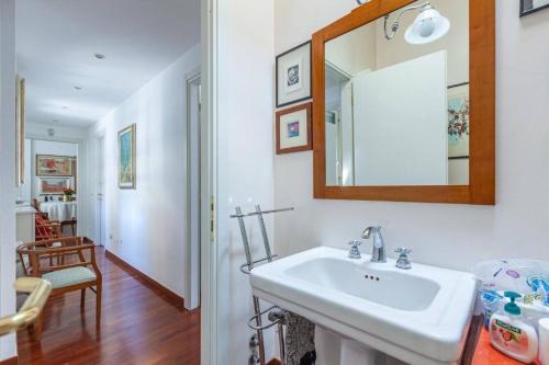 baño con lavabo y espejo en la pared en Noisette Casa con giardino en Milán