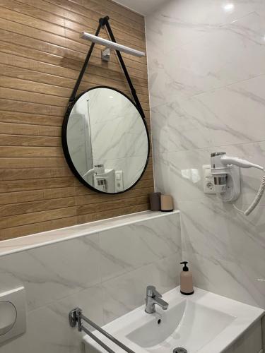 a bathroom with a mirror and a sink at Apartmani Višnja in Crikvenica