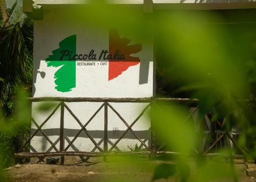 a sign for a pizza hut on a wall at Hotelito El Cuyo in El Cuyo