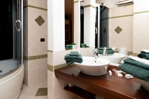 a bathroom with two sinks and a mirror and a tub at Apartament CENTRAL 1 in Drobeta-Turnu Severin