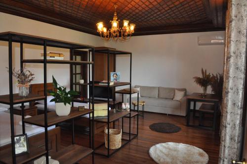 a living room with a couch and a chandelier at Timber Guest House in Berat