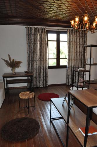 a living room with wooden floors and a large window at Timber Guest House in Berat