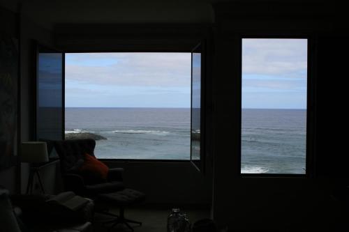 a room with two windows looking out at the ocean at Las Canteras Beach in Las Palmas de Gran Canaria