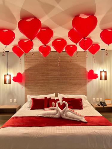 a room with a bed with hearts hanging from the ceiling at Hotel Buena Vista Express in Bucaramanga