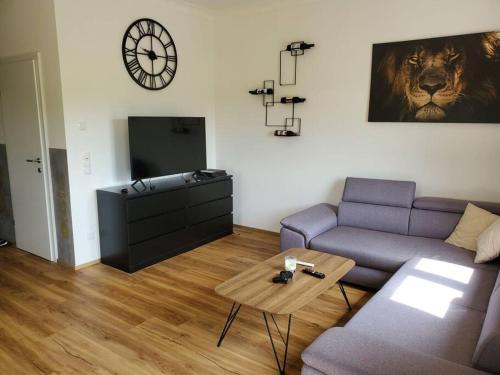 a living room with a couch and a table at Appartement Herzer in Gabersdorf